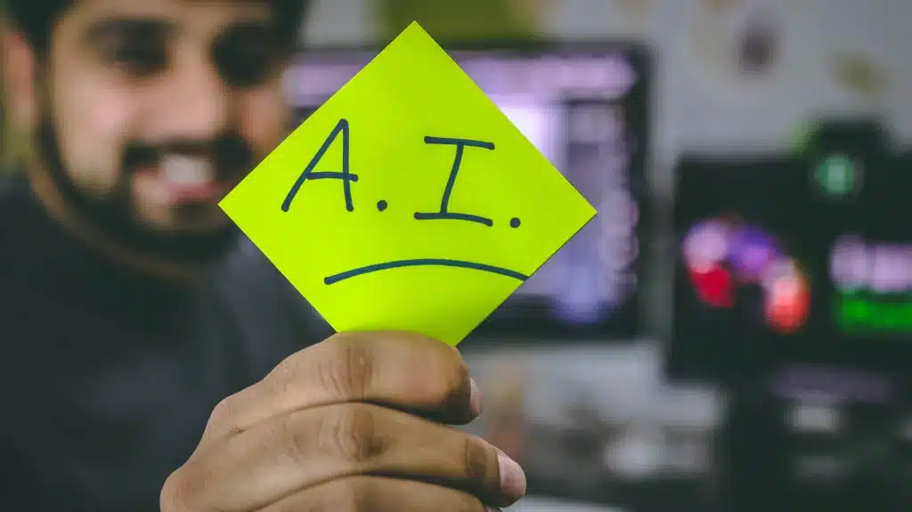Person holding note that reads AI. Referring to AI writing cover letters 