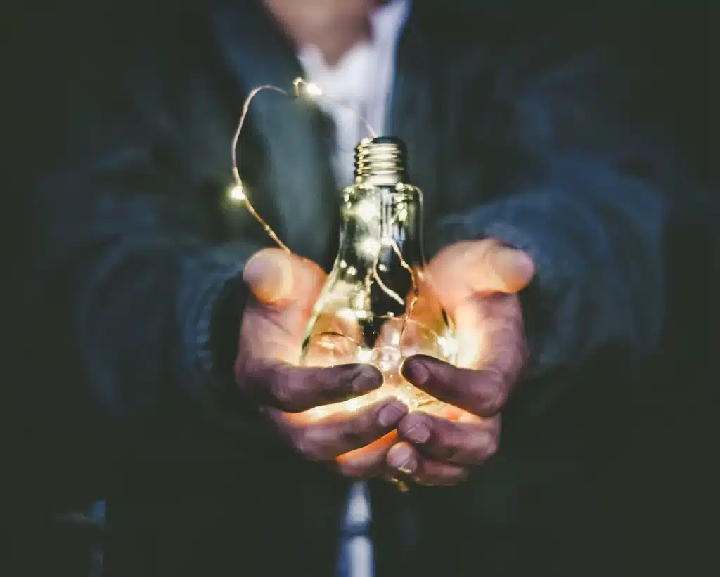 A man holding a bulb meant to represent the opportunity that business grant in Canada bring 